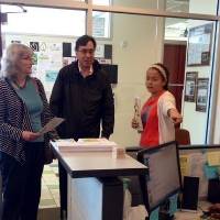 Women's center employee helping 2 guests